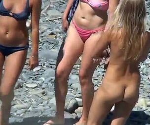 Beach spycam demonstrates us some nude damsel nudists. Go