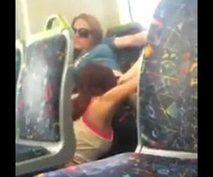 Dissolute damsel tonguing out her buddy on public transport